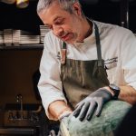 Chef Eric Cartwright cutting a watermelon.
