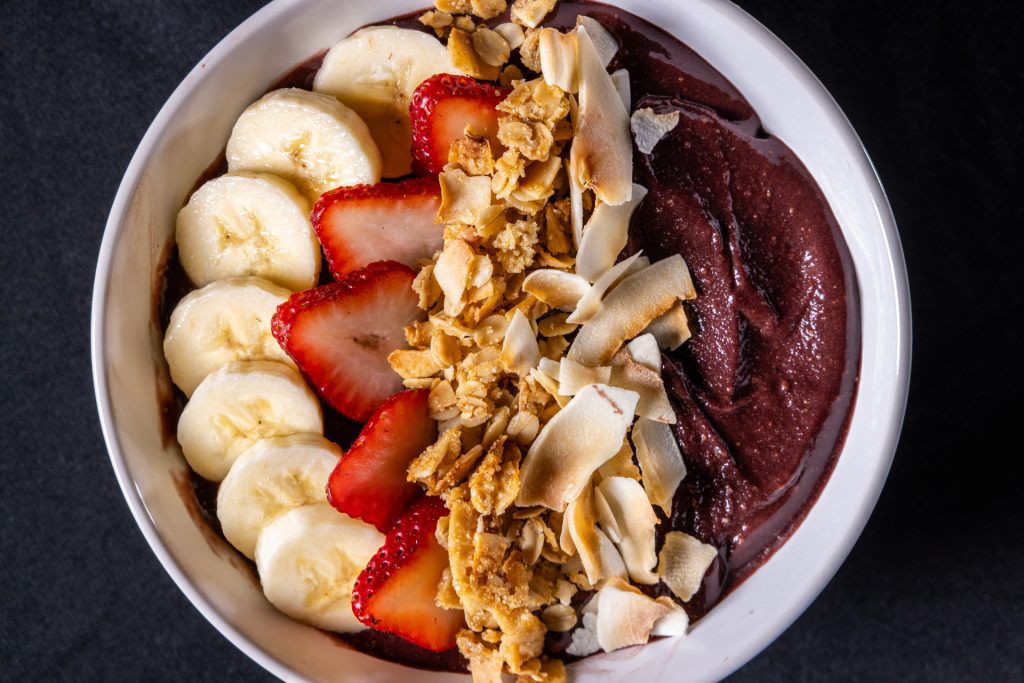 Acai bowl with bananas, strawberries and other fruit and nuts