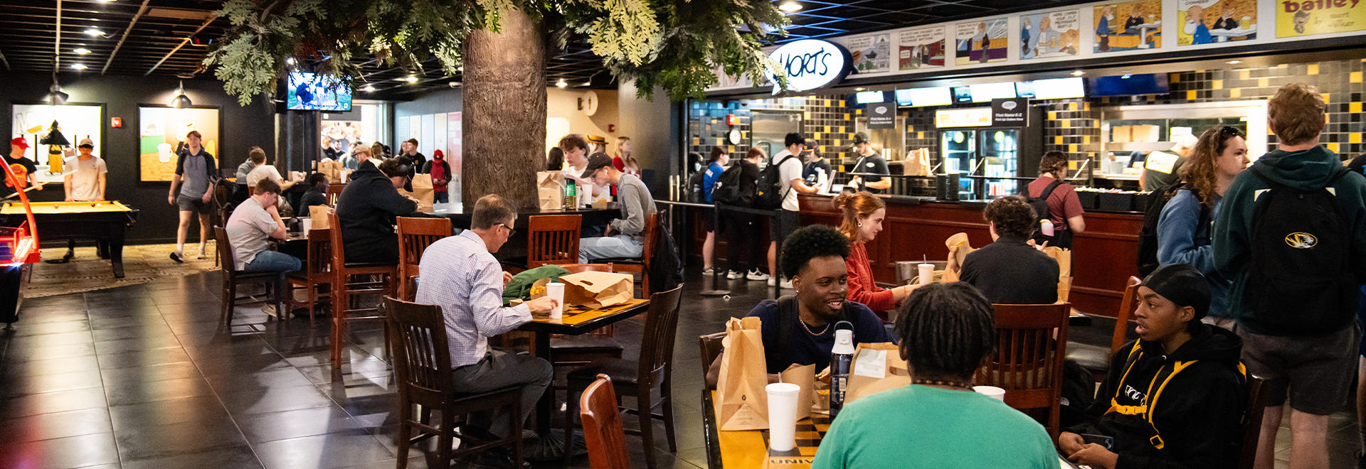 People eating at tables inside Mort's