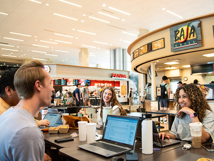 Students laugh while having lunch in the MU Student Center