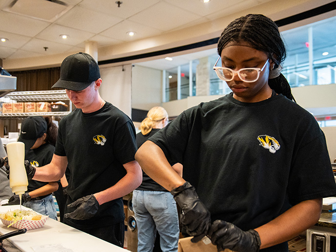 Student employees preparing food