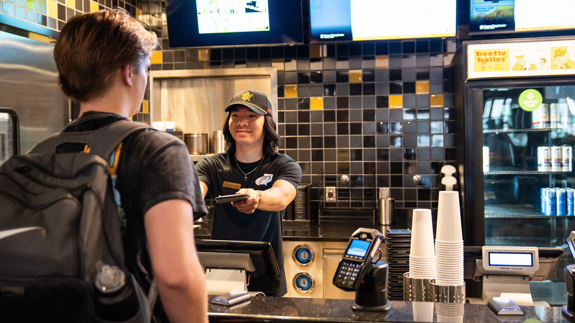 Campus dining student worker serves a student