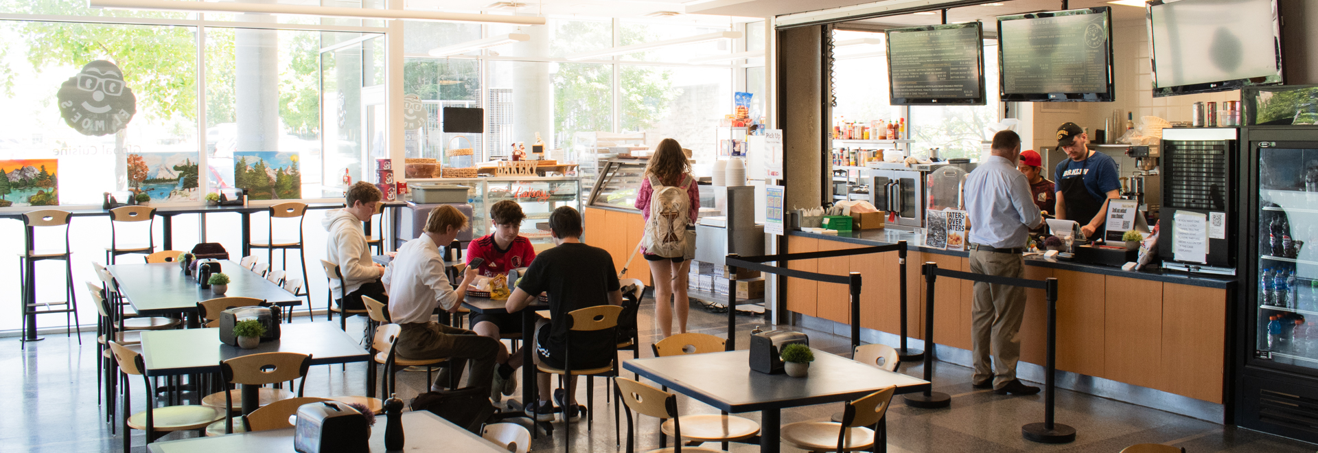 Students sitting and eating in restaurant