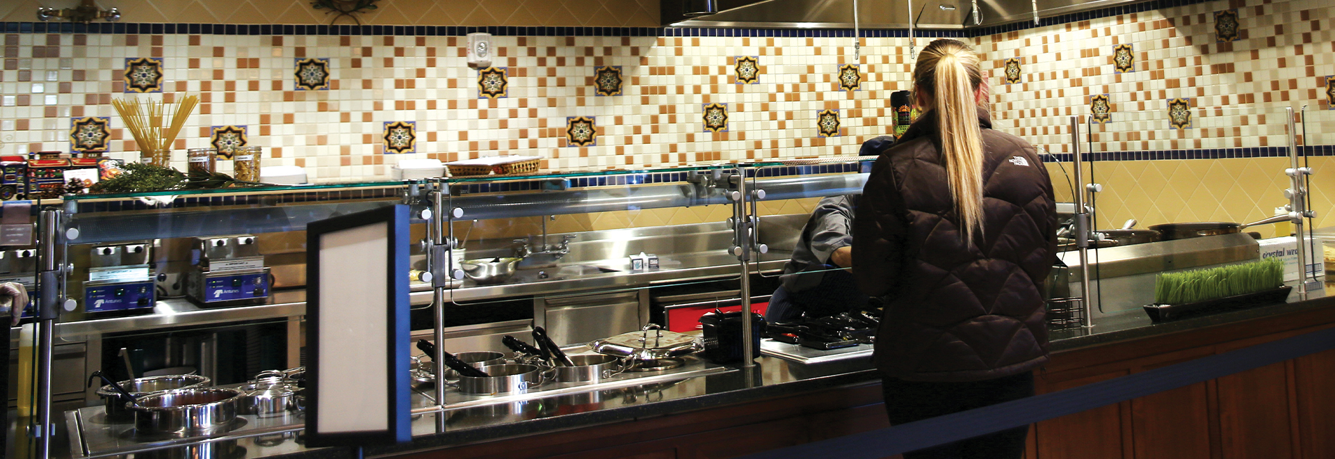 Olive + Oil storefront with customer at register